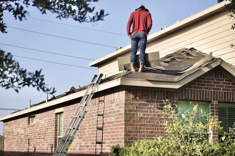 Professional roofer working on a residential roof in Bergenfield